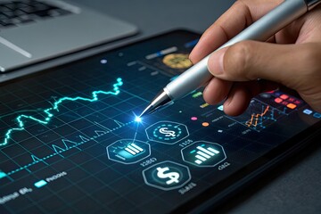 Hand using a stylus on a tablet displaying financial data and analytics graphs in an office