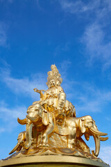 The golden statue of Buddha with elephant mount at the summit of Mount Emei, Sichuan, China.