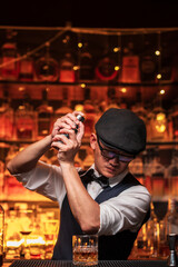 Bartender is pouring whiskey into a glass a customer's glass.