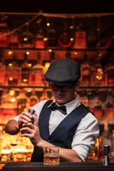 Bartender is pouring whiskey into a glass a customer's glass.	
