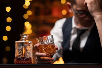 Bartender is pouring whiskey into a glass a customer's glass.	

