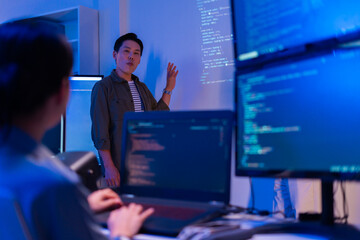 Asian software engineer or programmer team working late in development office,problem solving or algorithm of ai assistant helping for work.software developer,digital technology security concept