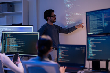Asian software engineer or programmer team working late in development office,problem solving or...
