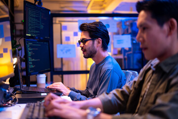 Asian software engineer or programmer team working late in development office,problem solving or...
