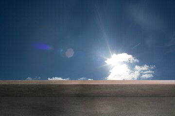 Cloud cluster is glowing under bright sun atop concrete ledge, casting lens flare in flat design