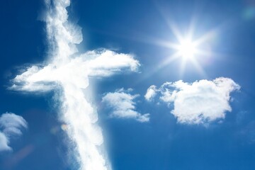 Cross shaped cloud formation is floating in flat design sky with sun rays and lens flare
