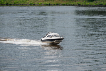 Motorboat goes fast on water.