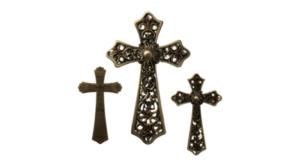 Three ornate antique gold crosses with intricate scrollwork designs isolated on a transparent background