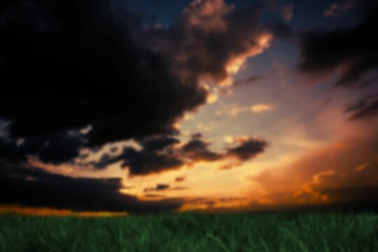 Fototapeta Land against cloudy sky during sunset