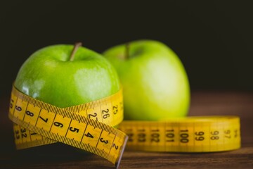 Green apples and measuring tape