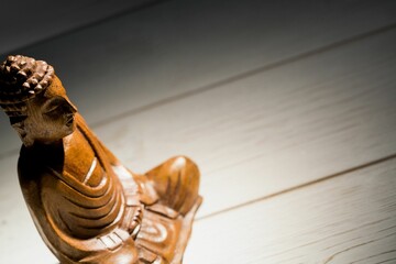 Buddha figurine on wooden floor