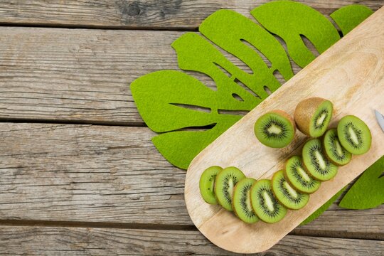 Kiwi slices on wooden cutting board