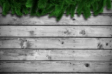 Obraz premium Blurred fir branches on wood