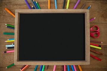 High angle view of empty chalkboard with colorful equipment