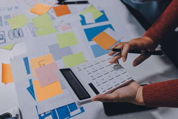 UX UI designer testing prototype on a phone, discussing and brainstorming on wireframes for a...