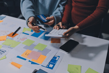 UX UI designer testing prototype on a phone, discussing and brainstorming on wireframes for a...
