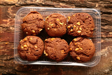 Chocolate muffins- top view snack foods background.