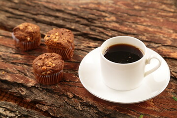Fresh brewed coffee served with chocolate cake muffins- cafe table backgrounds.