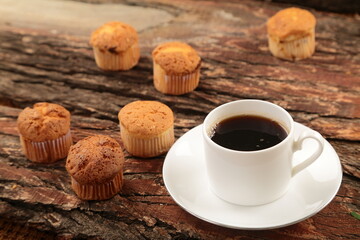 Break time- coffee and fresh baked muffins café background.