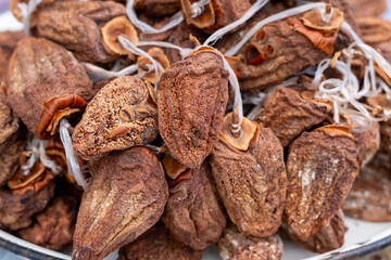 Dried persimmon fruits are sold at the market. Fruits