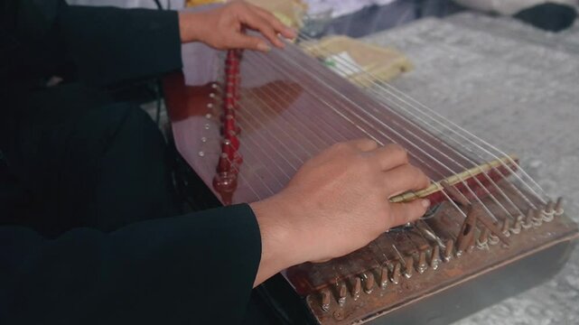 Musicians play the Kecapi (Harp) instrument. Kecapi is a traditional Sundanese stringed instrument from West Java, Indonesia, played by plucking.