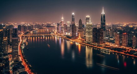 Fototapeta premium A glowing city skyline at night with lights reflecting on a river surface, viewed from above
