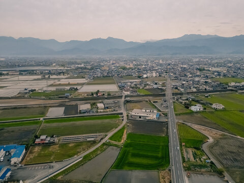 Aerial view over rural countryside rice and farm fields in japan