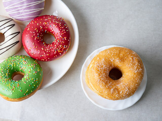 Donuts with colorful icing glazed designs on a white background. Copy free space