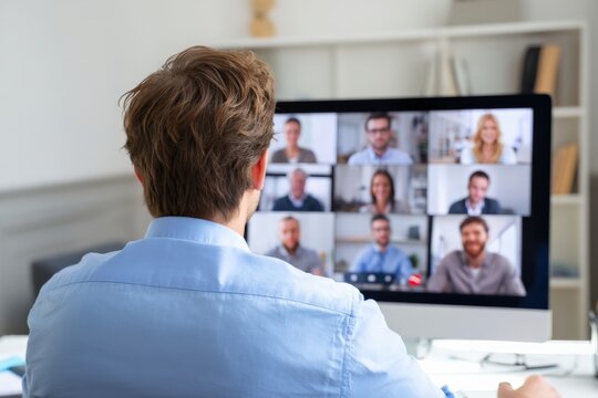 Office worker attending online meeting with business team using video conference software on computer