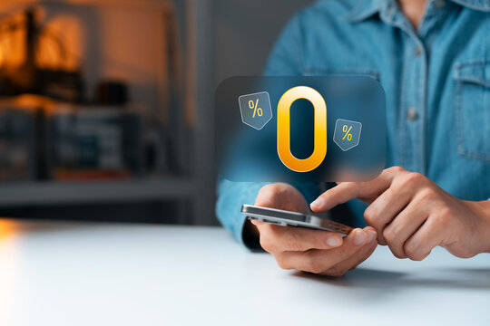 Zero percent interest promotion concept with Young man a hand using smartphone and glowing 0% sign, representing online shopping, finance deals, and digital discount campaigns.