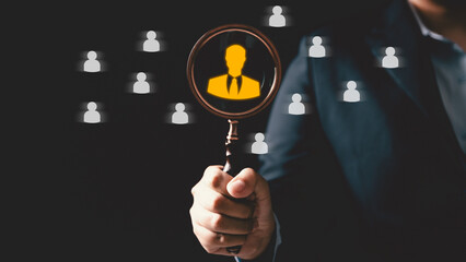 Concept of human resource recruitment visuals of magnifying glass highlighting ideal candidate icon, symbolizing process of headhunting, talent acquisition, employee selection, effective hiring.