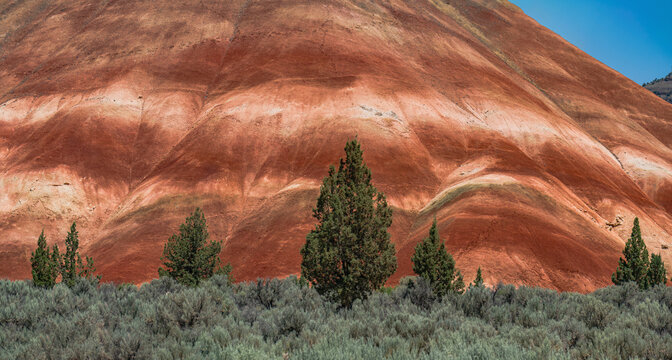 Colorful red painted hills caused by erosion, climate changes and volcanic activity in Eastern Oregon.