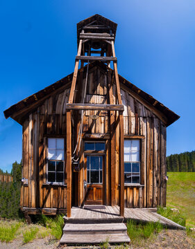 Old wooden one room school house in in a n old western ghost town.