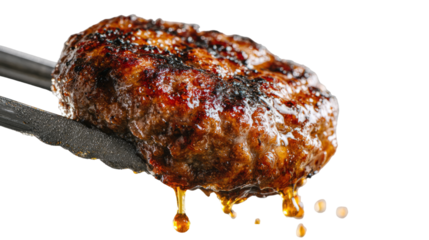 Juicy burger patty held in tongs, dripping with grilled fat, sizzling on white backdrop