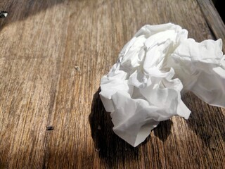 crumpled tissue texture on wooden background