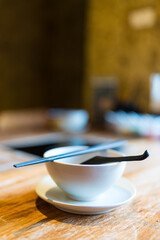 Close up of soup spoons with bowl and chopsticks for customer
