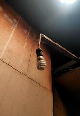 Old Bulb and Cobwebs Under Ceiling Shadow