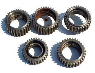 Five used metal gears on white background