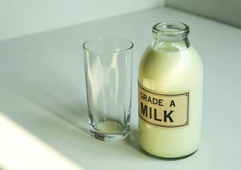Grade a milk in glass bottle and empty glass