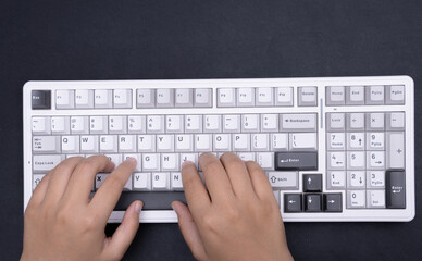 Photographic close-up of hands typing on white keyboard modern tech imagery for blogs websites...