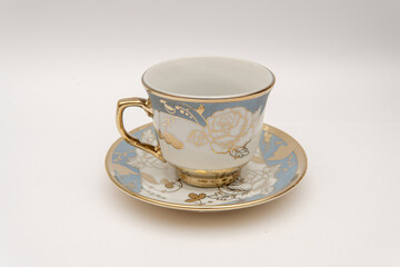 Elegant photograph of porcelain teacup and saucer with floral design ideal for lifestyle blogs vintage decor or tea party invitations classic style