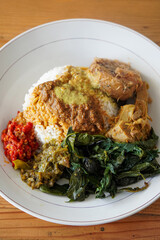 Nasi Padang with Rendang Sauce, Indonesia, captured on June 29, 2025. Traditional Minang rice dish served with rich and spicy rendang sauce, accompanied by vegetables and sambal.