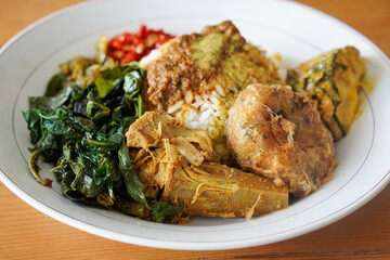 Nasi Padang with Rendang Sauce, Indonesia, captured on June 29, 2025. Traditional Minang rice dish served with rich and spicy rendang sauce, accompanied by vegetables and sambal.