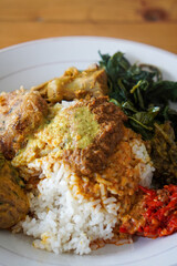 Nasi Padang with Rendang Sauce, Indonesia, captured on June 29, 2025. Traditional Minang rice dish served with rich and spicy rendang sauce, accompanied by vegetables and sambal.
