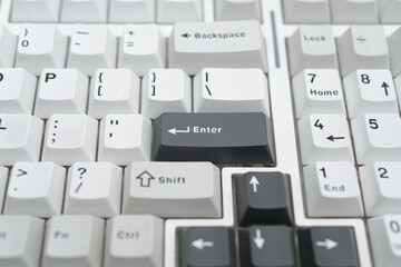Monochromatic photographic detail of a computer keyboard enter key ideal for tech blogs minimalist...
