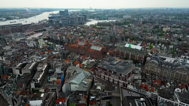 Drone glides right over calm downtown Amsterdam during the day in 60fps