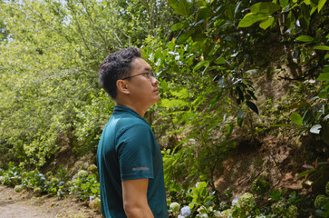 A man standing in the forest, solo travel, connecting with nature and him inner self, forest...