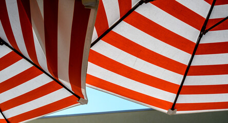 Graphic red and white stripes on a sun umbrella.