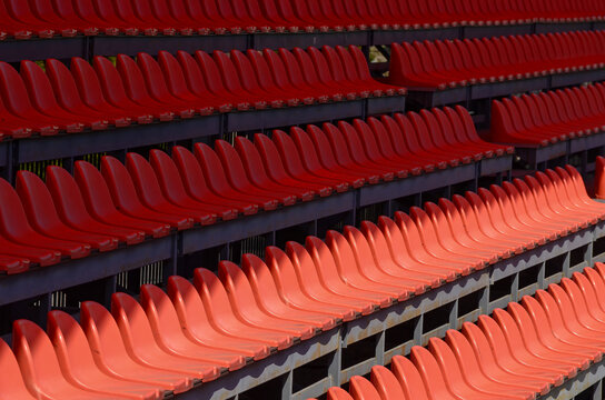 The empty seats are red and arranged in rows. Concept of emptine