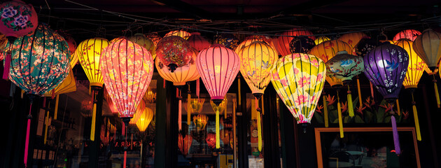 Colorful silk lanterns illuminating a parisian street at night © Cavan